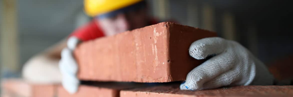 construction worker laying bricks