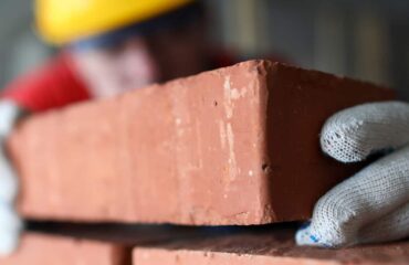 construction worker laying bricks